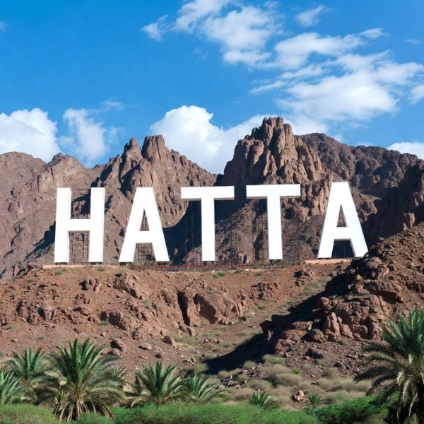 Hatta sign landmark surrounded by rocky Hatta Mountains in the UAE